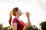 Sporty Woman Drinking Water On Sunlight Stock Photo