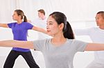 Sporty Woman Stretching Her Hands Yoga Class In Fitness Studio Stock Photo