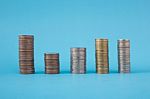 Stack Of Coins On Blue Soft Background Stock Photo