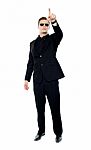 Standing Young Man Pointing Upwards Stock Photo