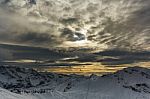 Stormy Clouds Over A Snowcaped Mountain Range Stock Photo