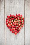 Strawberries Of Heart On Wood Stock Photo