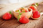 Strawberry In A Bowl On Wooden Background Stock Photo