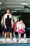 Strong Fit Man And Woman Posing Casually Stock Photo