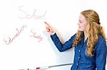 Student Pointing At School Words At Whiteboard Stock Photo