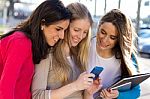 Students Having Fun With Smartphones After Class Stock Photo