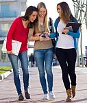 Students Having Fun With Smartphones After Class Stock Photo