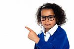 Studio Shot Of A Melancholic Girl Pointing Sideways Stock Photo