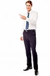 Stylish Young Businessman Pointing Away Stock Photo