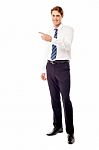 Stylish Young Businessman Pointing Away Stock Photo