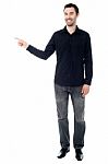 Stylish Young Guy Pointing Away Stock Photo