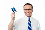 Successful Businessman Holding A Credit Card Stock Photo