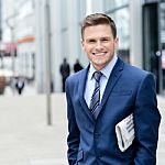 Successful Businessman Holding Newspaper Stock Photo