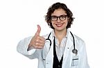 Successful Young Doctor Showing Thumbs Up Stock Photo