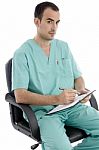 surgeon writing on clipboard Stock Photo