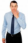 Surprised Businessman With Hand On Mouth Stock Photo