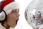 Surprised Woman Looking To Disco Ball And Wearing Christmas Hat Stock Photo