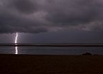 Surreal, Stormy Night Enlightened By Thunder On The Coastline In Stock Photo