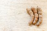 Sweet Ripe Tamarind Pods On Wood Background Stock Photo