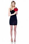 Tall Attractive Girl Holding Heart Shaped Gift Stock Photo