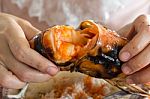 Tear The Grilled Shrimp By Hands Stock Photo