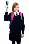 Teen Girl In Uniform Holding Up A Cash Card Stock Photo