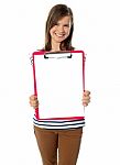 Teen Showing Paper On Clipboard Stock Photo