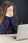 Teen Sitting At Table With A Laptop Stock Photo