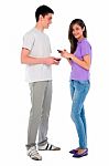 Teenage Couple Holding Smartphone Stock Photo