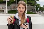 Teenager Eating Cake Looking In Phone Stock Photo