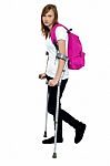 Teenager Student Holding Crutches And Walking Stock Photo