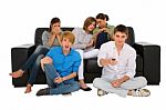 Teenagers holding TV remote Stock Photo