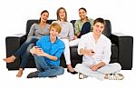 Teenagers holding TV remote Stock Photo