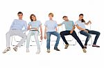 Teenagers Sitting On Chairs Stock Photo