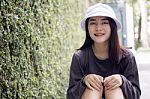 Thai Adult Girl White Cap Gray T-shirt Beautiful Girl Relax And Smile Stock Photo