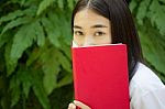 Thai Adult Student University Beautiful Girl Reading Red Book Stock Photo