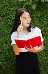 Thai Adult Student University Beautiful Girl Reading Red Book Stock Photo