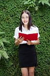 Thai Adult Student University Beautiful Girl Reading Red Book Stock Photo