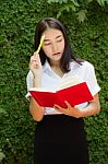 Thai Adult Student University Beautiful Girl Reading Red Book Stock Photo