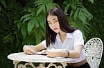 Thai Adult Student University Beautiful Girl Reading Red Book Stock Photo