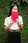 Thai Adult Student University Beautiful Girl Reading Red Book Stock Photo