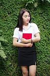 Thai Adult Student University Beautiful Girl Reading Red Book Stock Photo