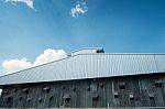 Thai Zinc Barn Against Blue Sky Stock Photo