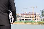 The Arms Of A Male Businessman Holding A Blueprint Stock Photo