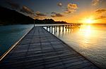 The Beautiful Wooden Pier With Sunrise At Rayong, Thailand Stock Photo