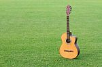 The Classic Guitar Is A Musical On The Grass Background Stock Photo