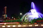 The Fountain At The City Intersection With The Building's Background Towering High Behind Stock Photo