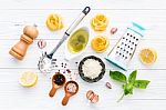 The Ingredients For Homemade Pesto Pasta On White Wooden Backgro Stock Photo