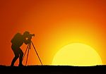 The Man Work With The Camera On A Background Of The Sun Stock Photo