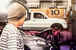 The Men Looking At  Mechanic In A Garage Stock Photo